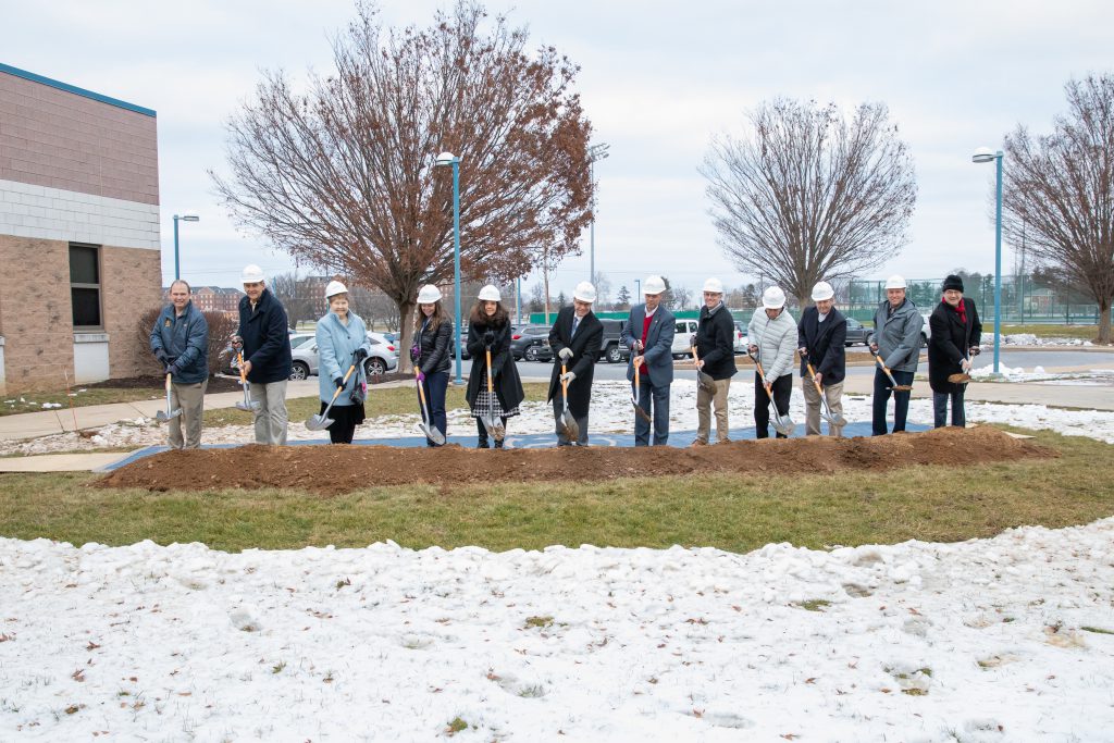 CLSD Board members, Administrators and Officials in constructions helmets use shovels to ceremoniously break ground for the three-phase Cedar Crest Campus Construction and Renovations Project.